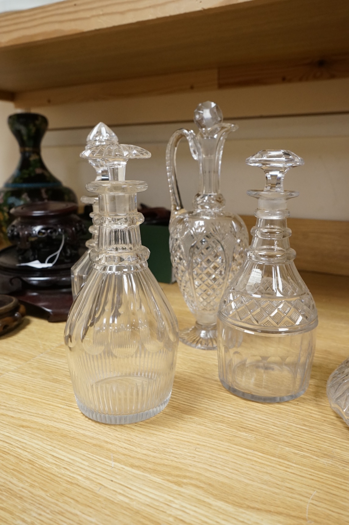 Three early 19th century cut glass decanters and two Victorian jugs, tallest 32cm
